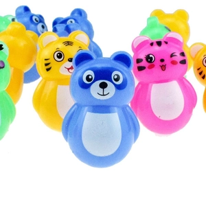 Close-up of colorful mini animal tumbler toys in blue, yellow, and pink on white background