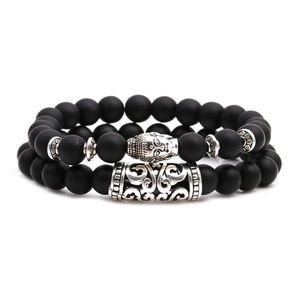 Matte black onyx beaded bracelet set with silver Buddha head and textured tube spacer
