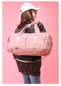 Side view of large pink yoga travel bag showing shoe compartment and waterproof texture