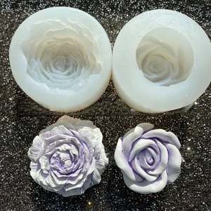 Detail of peony and rose silicone molds with finished plaster flower casts.