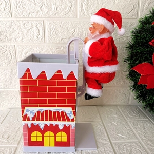 Electric climbing Santa Claus toy on a red chimney with music for Christmas holiday decor