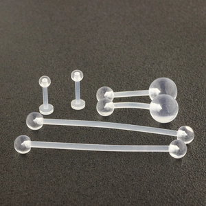 Detailed view of clear acrylic body jewelry set including tongue barbells and labret studs