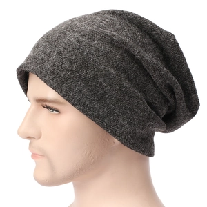 Close-up of thick knitted dark grey slouchy beanie showing texture and ribbed details