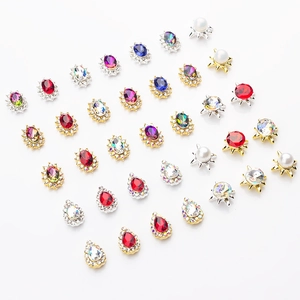 Macro view of assorted K9 colorful alloy nail charms in teardrop and oval crystal shapes