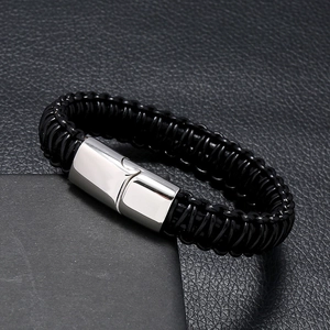 Detail of multi-strand black braided leather bracelet with silver magnetic metal clasp