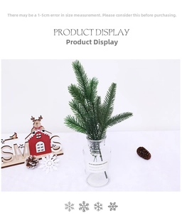 Macro detail of artificial pine needles in a glass vase with Christmas decor