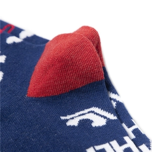 Macro view of navy cotton sock with reinforced red heel and intricate white jacquard pattern