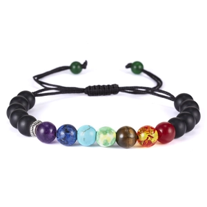 Macro detail of adjustable chakra bracelet with matte black beads and colorful stones