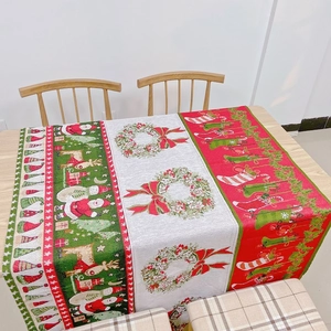 Detail of Christmas table runner with Santa Claus, reindeer patterns and thick fabric texture