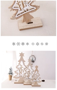 Detailed view of three tiered wooden Christmas trees with white reindeer cutouts and bases