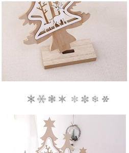 Detailed view of wooden Christmas tree decor with laser-cut reindeer and star patterns