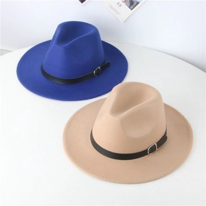 Detail of navy and camel wool fedora hats with leather belts in a flat lay view