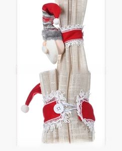 Detail view of Santa gnome curtain tieback showing side profile and back button closure