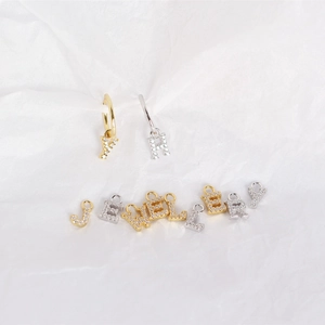 Detailed view of S925 sterling silver letter earrings with sparkling cubic zirconia inlay