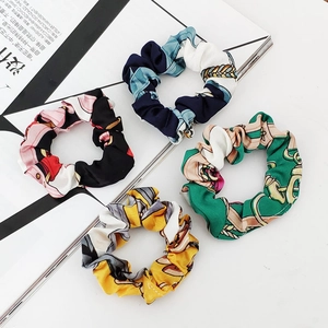 Set of 4 vintage velvet scrunchies with floral and chain patterns on a white background