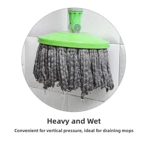 Vertical wall-mounted mop holder showing a heavy wet mop head dripping water to dry