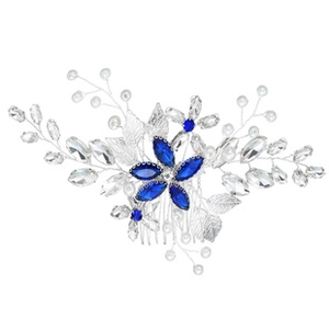Detailed shot of handmade bridal hair comb with blue gems, pearls and silver leaves