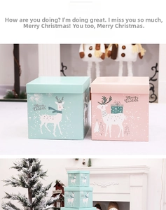 Detail of mint green and pink Christmas gift boxes with reindeer and Merry Christmas text