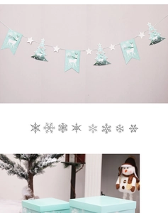 Detail of mint green Merry Christmas banner with snowflake stickers and gift box decor