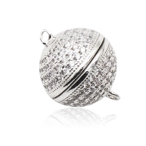 Macro shot of silver plated spherical magnetic clasp with cubic zirconia for jewelry making