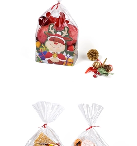Detail of Christmas gift bag with reindeer base card filled with snacks and a red tie