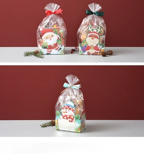 Close-up of Christmas treat bags with Santa, reindeer and snowman paper base and ribbons