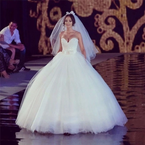 Robe de mariée bustier blanche de style bal avec décolleté en cœur et ceinture à nœud