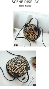 Detail of round leopard print cat shaped handbag with gold whiskers and heart clasp
