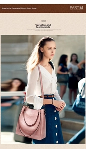 Street style view of the large pale pink leather bucket bag worn by a model outdoors