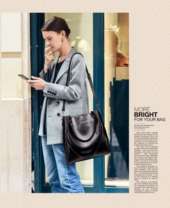 Fashion editorial layout showing black leather bucket bag with top handles and strap