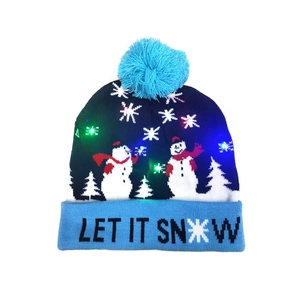 Close-up of LED knit hat featuring Let It Snow text and colorful glowing snowman pattern