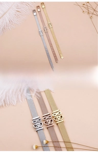 Detail of mesh band bracelets featuring heart and infinity charms in three metallic tones