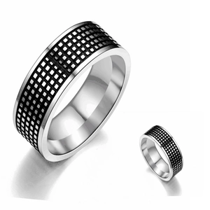 Detailed macro view of retro stainless steel ring with black checkered pattern inlay