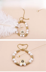 Detail of pearl bracelet with gold tree of life charm and adjustable slider clasp