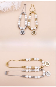 Detail of pearl titanium steel bracelet with tree of life charm and adjustable slider