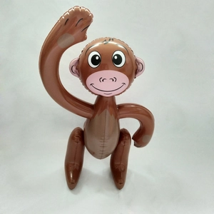 Detail view of a cute brown inflatable monkey toy made of glossy PVC material