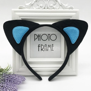 Detail of plush black cat ear headband with light blue inner padding for party costumes
