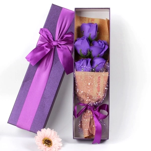 Macro shot of 4 purple soap roses in a rectangular gift box with matching purple ribbons