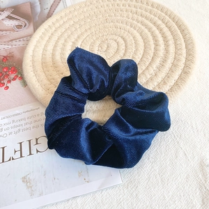 Detail showing high-quality navy blue velvet fabric texture on minimalist hair scrunchie