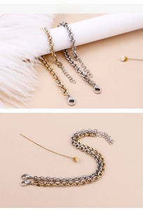 Detailed view of gold and silver round link chain bracelets with lobster clasp closure