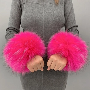 Close-up of pink faux fur wrist cuffs showing fluffy texture and soft plush material