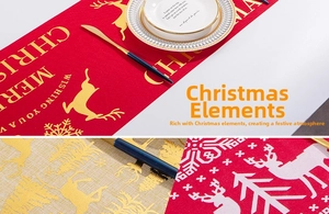 Close-up of linen Christmas table runner with gold reindeer and snowflake prints