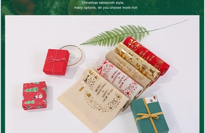 Detail of linen Christmas table runners with gold foil reindeer and snowflake patterns