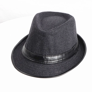 Top view detail of a dark grey fedora hat featuring a black faux leather band and neat stitching