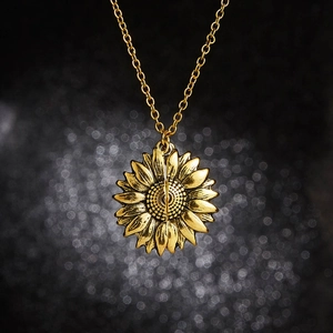 Detailed close-up of golden sunflower pendant with layered petals and textured center