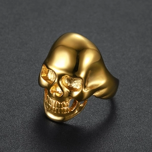 Macro shot of polished gold skull ring with intricate gothic punk metalwork detailing