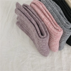Detailed close-up of ribbed wool blend socks in purple, pink, grey and black colors