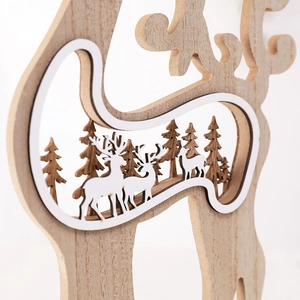 Hollow-out wooden Christmas reindeer ornament with forest scene decor in natural wood tones