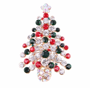 Detailed close-up of a Christmas tree brooch with colorful rhinestones on gold metal