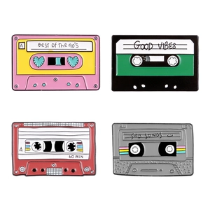 Set of four retro enamel cassette tape pins featuring 90s vibes on white background